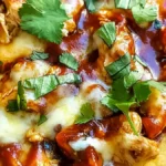 BBQ flatbread with chicken, melted cheese, barbecue sauce, and fresh cilantro leaves.