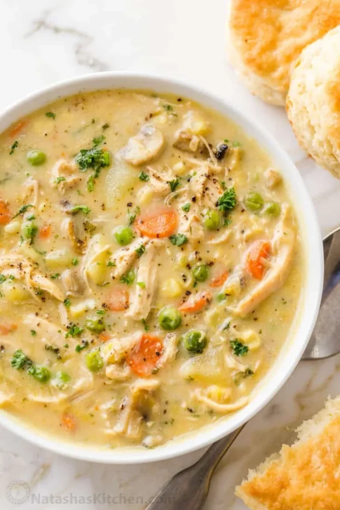 Bowl of creamy Chicken Pot Pie Soup garnished with herbs