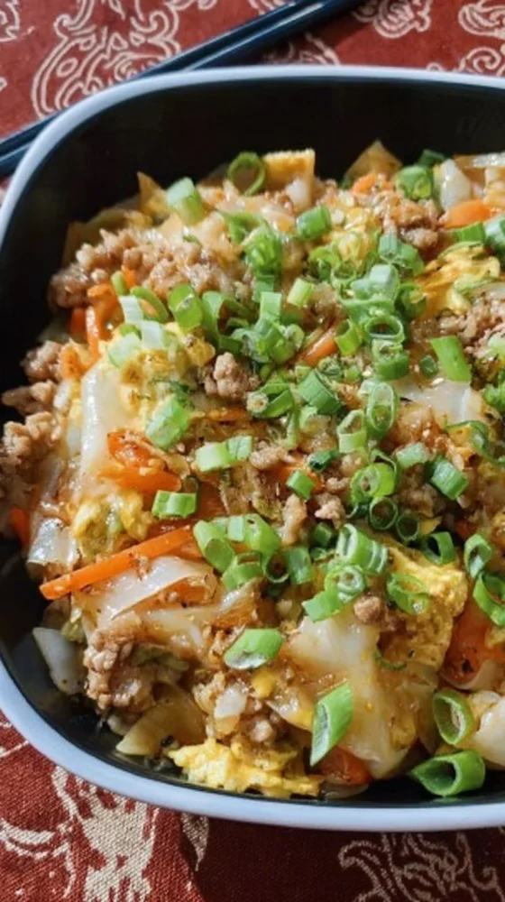 Delicious Egg Roll in a Bowl served with fresh vegetables and sauce.