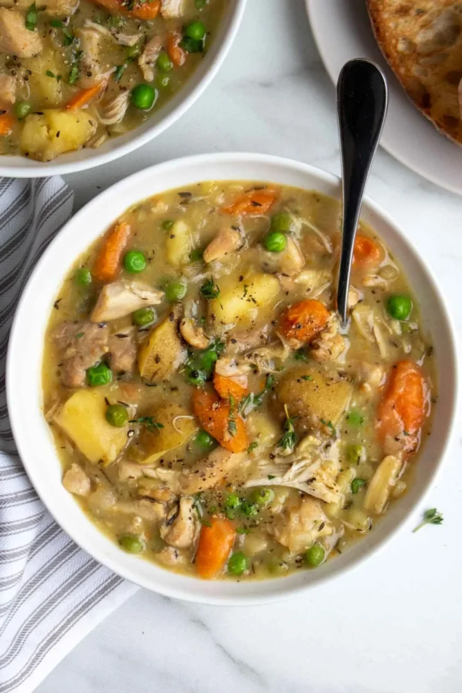 Delicious slow cooker chicken stew with vegetables and herbs in a bowl