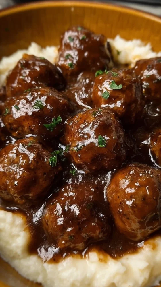 Plate of Slow Cooker Salisbury Steak Meatballs served with gravy and vegetables